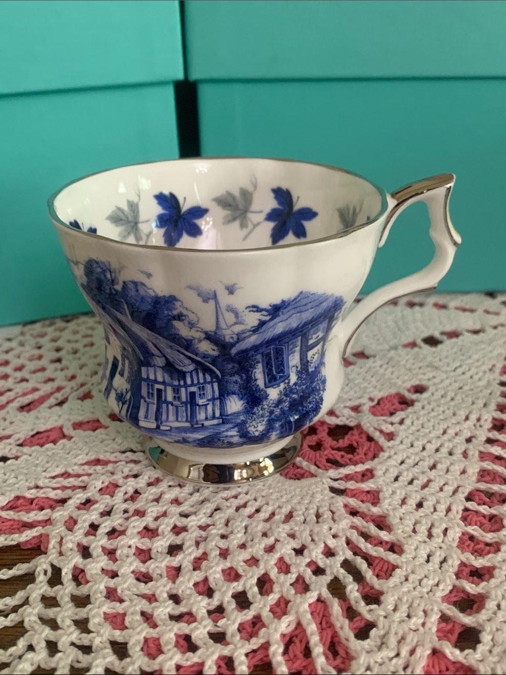 Blue Cottage-Scene Porcelain Teacup with Gold Trim
